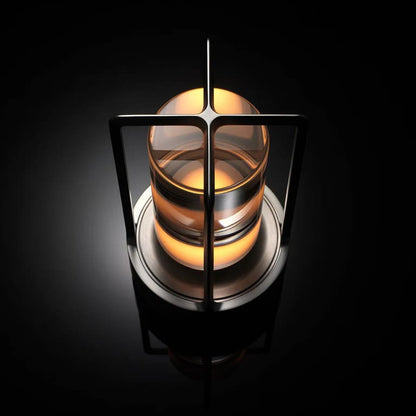 AMBIENTIFY Retro cordless retro table lantern lamp casting a warm amber glow, placed on a wooden tray. Slender aluminium frame with cylindrical acrylic glass shade. Atmospheric home décor lighting for bedroom, living room or outdoor use.