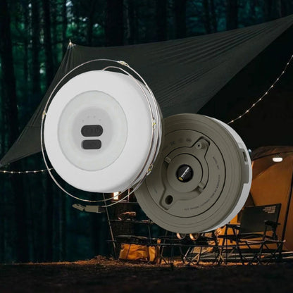 Campify String fairy light reel held in hand at night, showing warm amber LED string lights extended across dark outdoor ground, compact hub glowing with blue charge indicator, IP67 waterproof camping and home fairy lights.